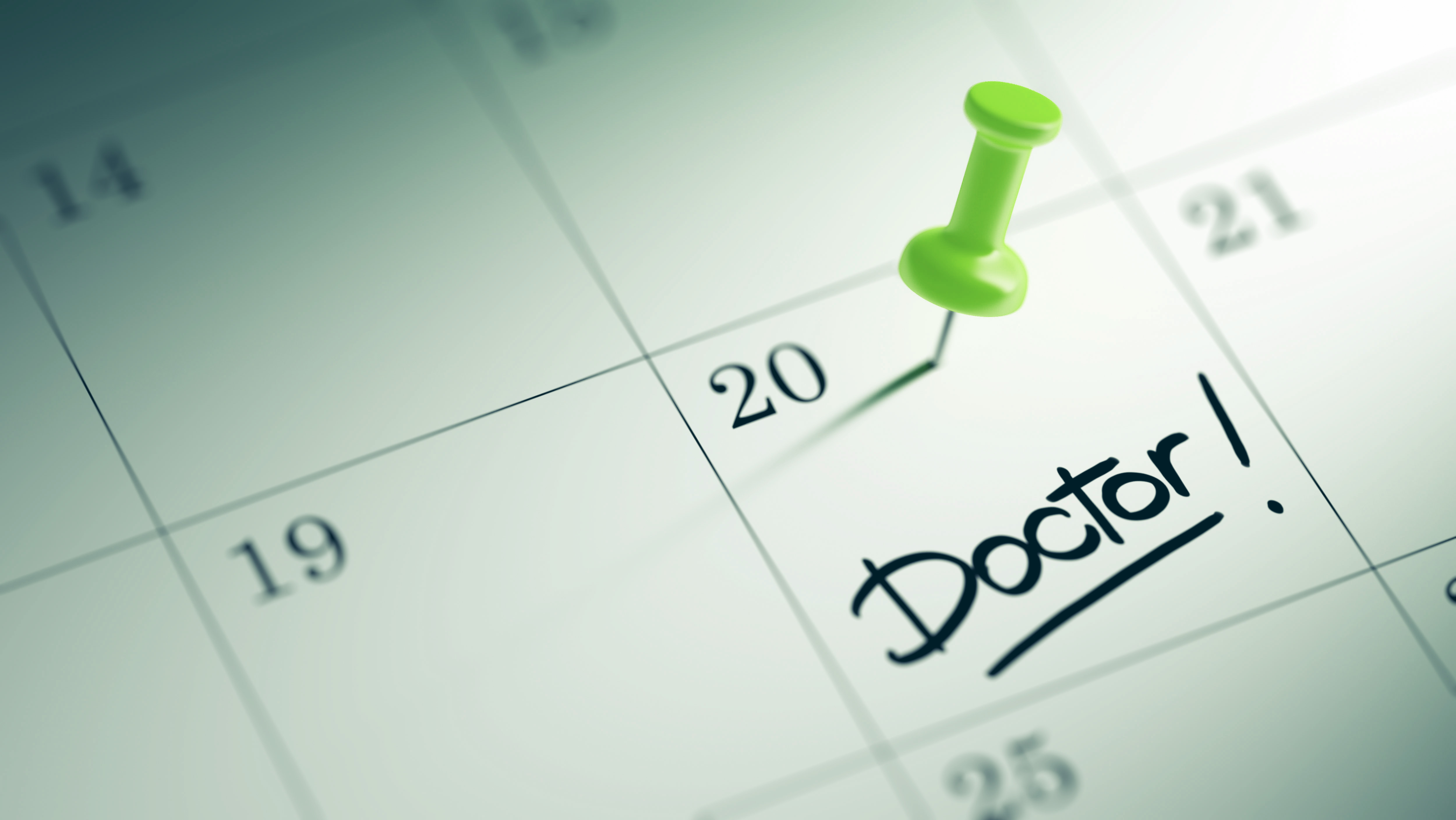 Calendar with a pushpin and reminder to go to the doctor