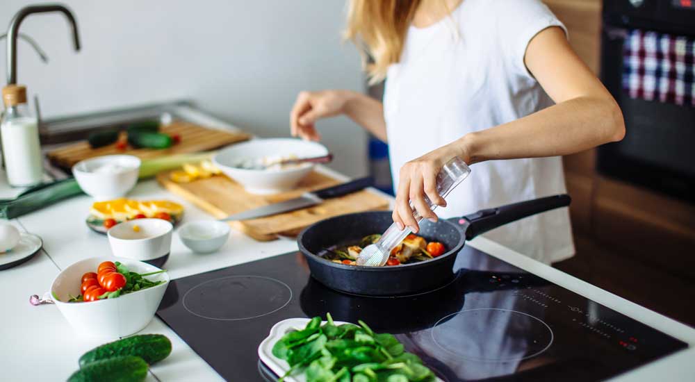 person cooking with fresh vegetables