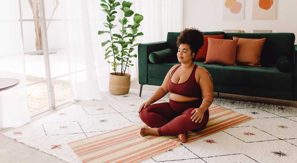 woman sitting crosslegged on floor