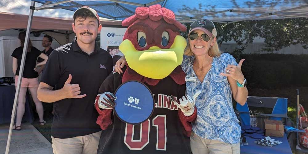 man and woman with cocky mascot