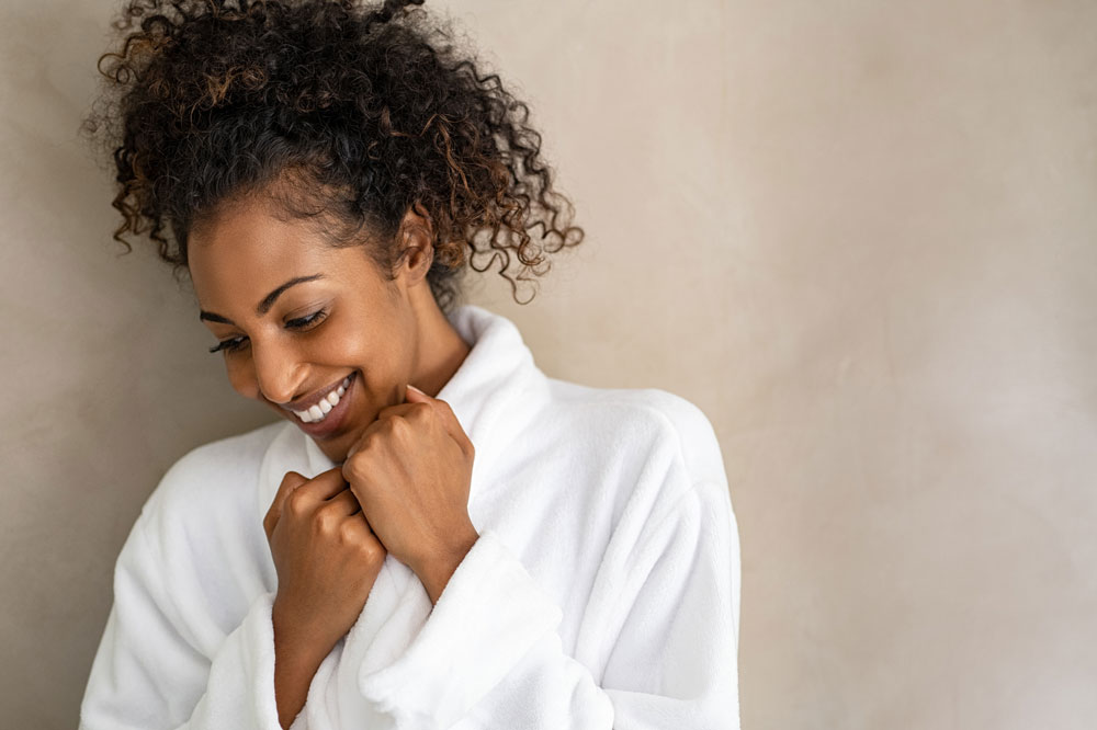 woman in robe smiling